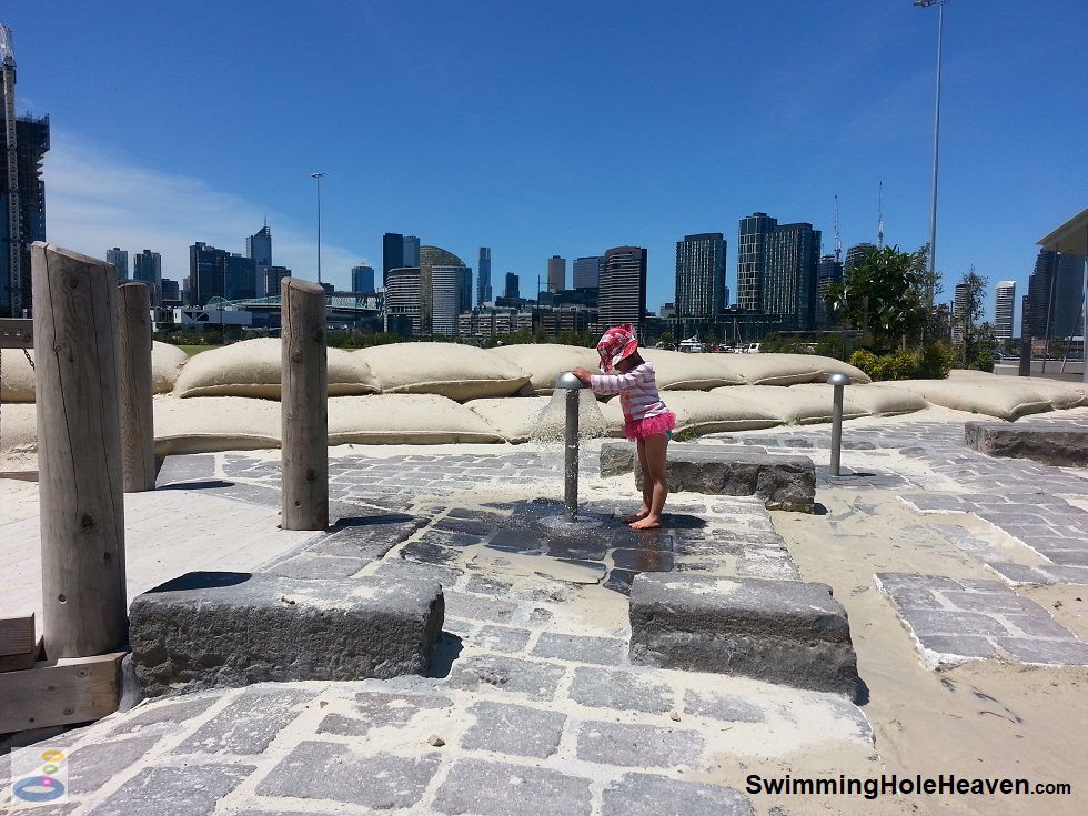 Playing with the mushroom water springs at Ron Barassi Snr Park, Docklands