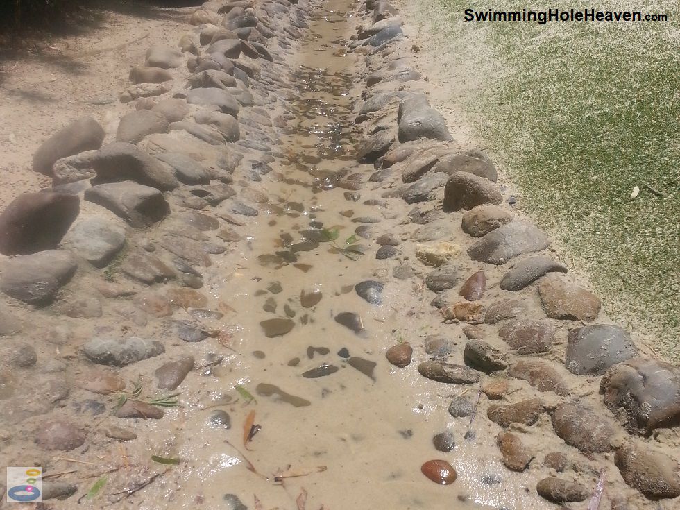 The pebbled stream running alongside the sandpit at the Ian Potter Childrens Garden